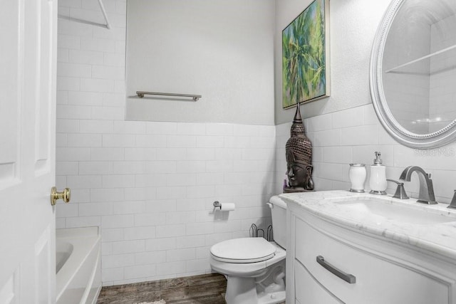 bathroom featuring hardwood / wood-style flooring, vanity, toilet, and tile walls