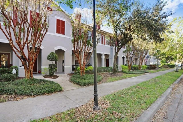 view of property with a residential view and stucco siding