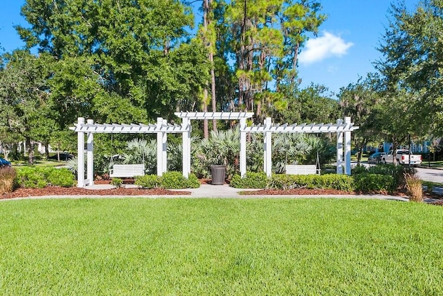 surrounding community with a lawn and a pergola