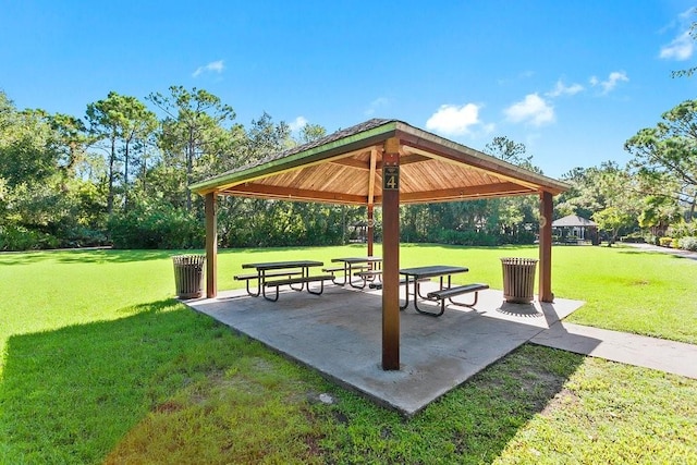 view of community with a gazebo, a lawn, and a patio area