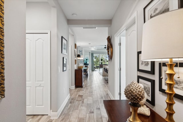 corridor with light hardwood / wood-style floors