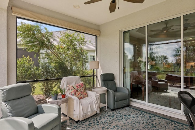 sunroom / solarium featuring ceiling fan