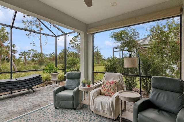 sunroom / solarium featuring ceiling fan