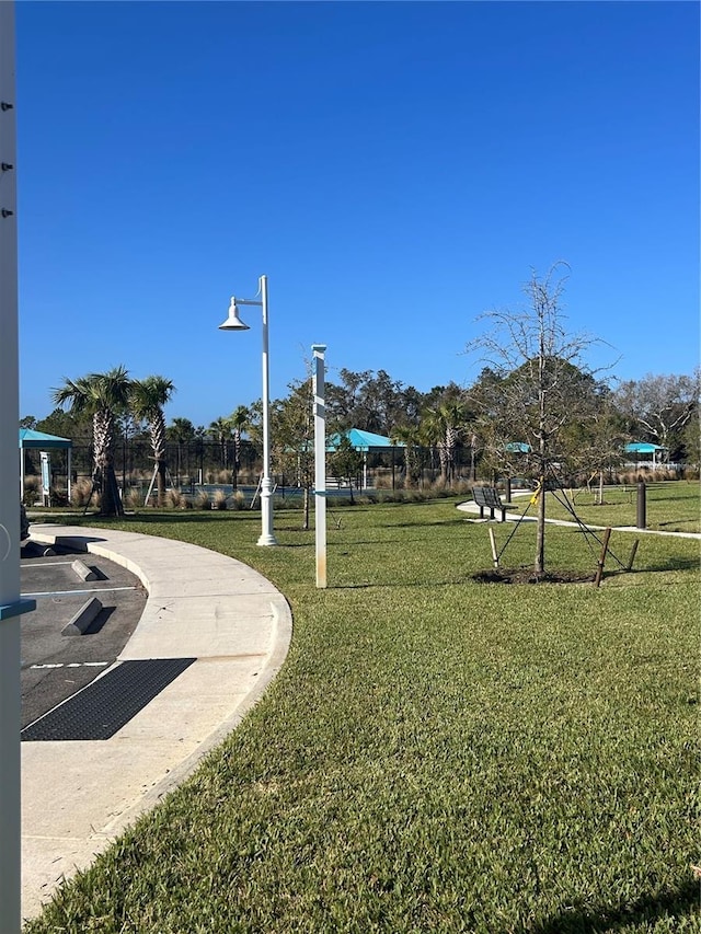 view of property's community with a yard