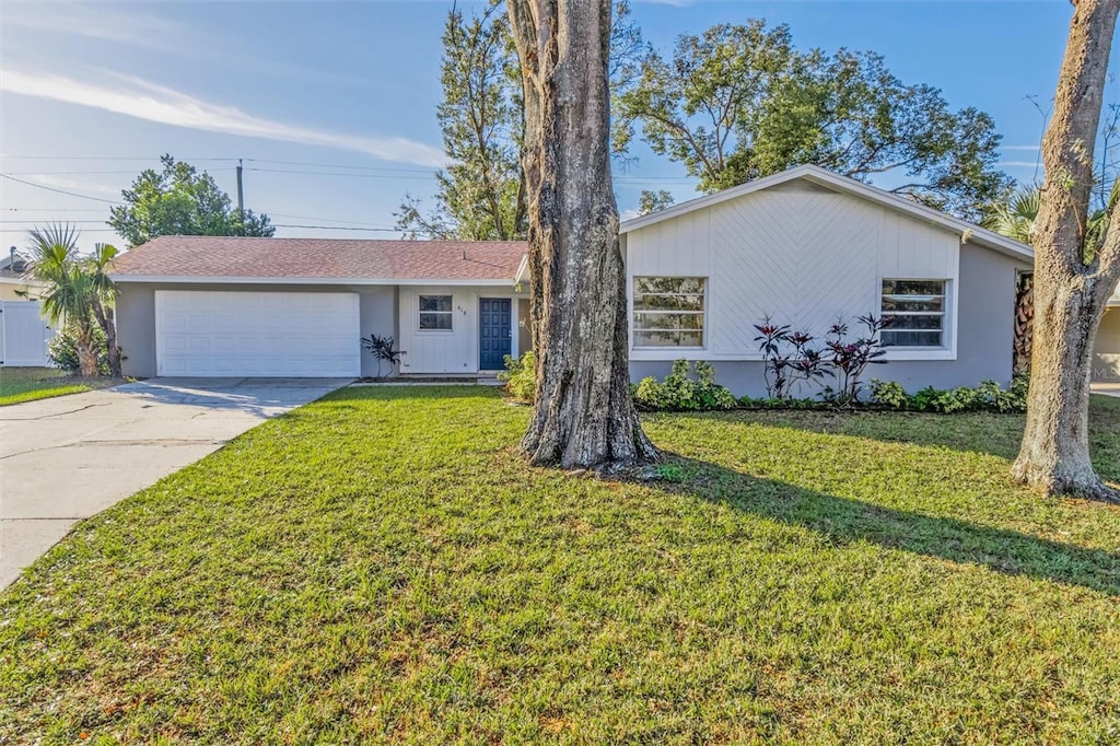 ranch-style house with a garage and a front yard