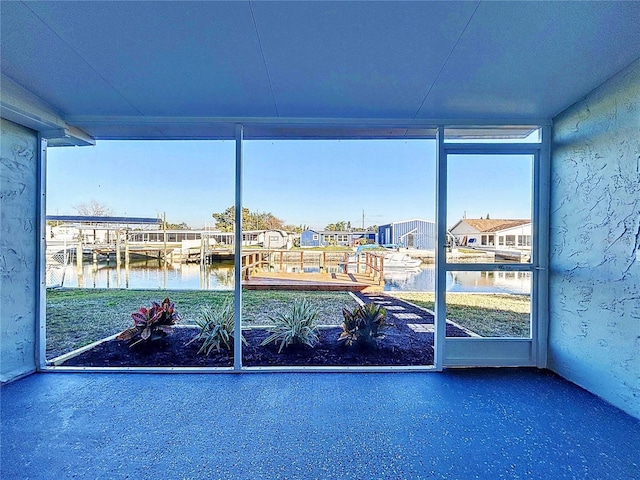 unfurnished sunroom with a water view