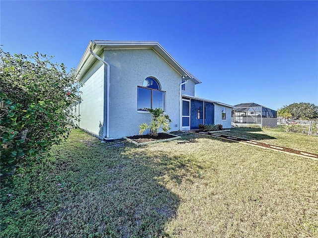 view of side of home featuring a yard