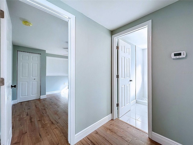 corridor with light hardwood / wood-style floors