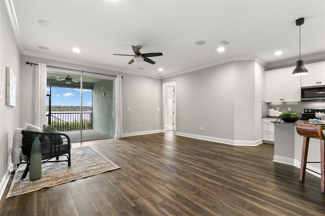 interior space featuring crown molding, ceiling fan, and dark hardwood / wood-style flooring