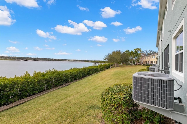 view of yard with a water view and central AC