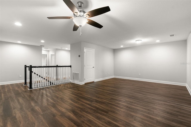 spare room with ceiling fan and dark hardwood / wood-style flooring