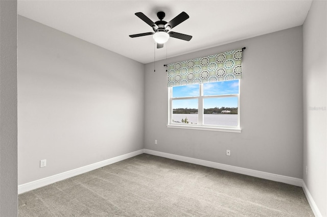 spare room with light carpet and ceiling fan