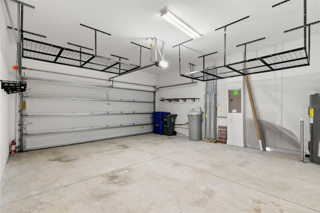 garage with a garage door opener and water heater