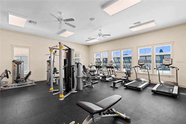 workout area featuring ceiling fan and ornamental molding