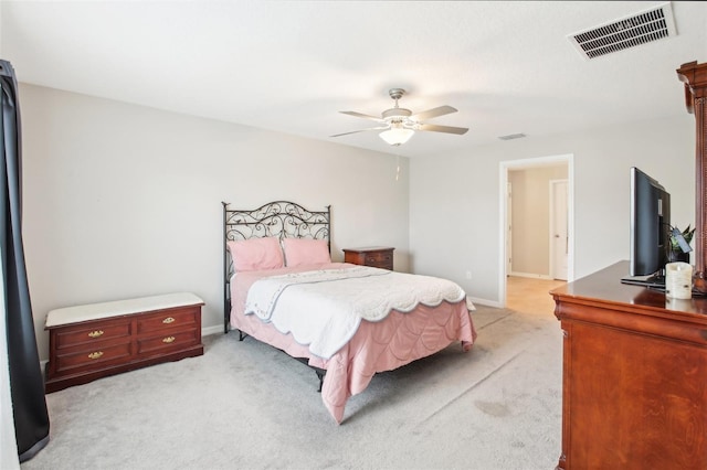 bedroom featuring light colored carpet and ceiling fan