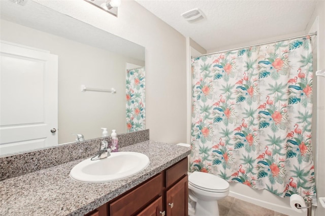 full bathroom with shower / bath combo, vanity, a textured ceiling, tile patterned floors, and toilet