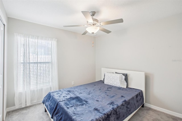 bedroom featuring light colored carpet and ceiling fan