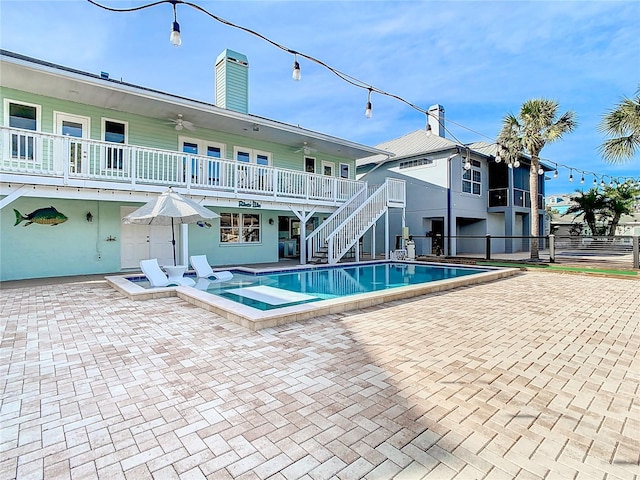 view of swimming pool with a patio and ceiling fan