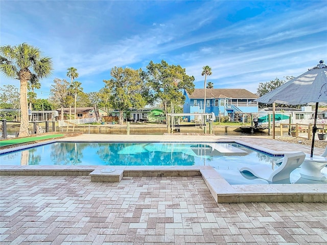 view of swimming pool with a patio and a hot tub