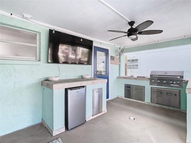 view of patio featuring an outdoor kitchen, area for grilling, sink, and ceiling fan