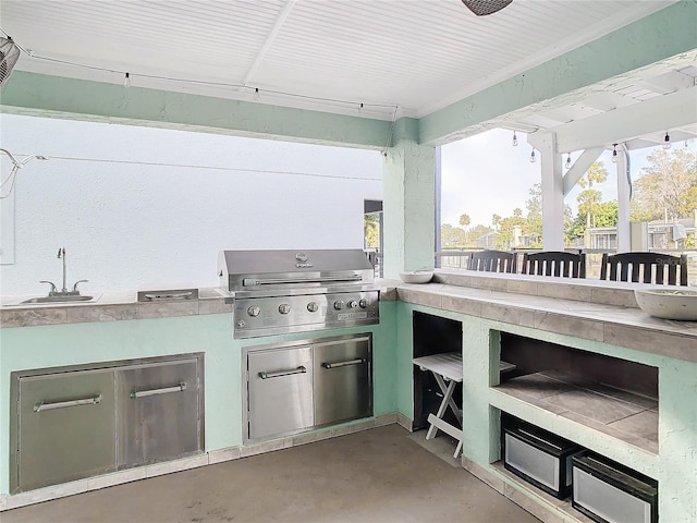 view of patio / terrace featuring area for grilling, an outdoor wet bar, and a grill