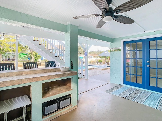 entryway featuring ceiling fan, concrete flooring, and french doors