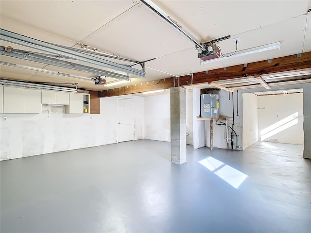 garage with electric water heater and a garage door opener