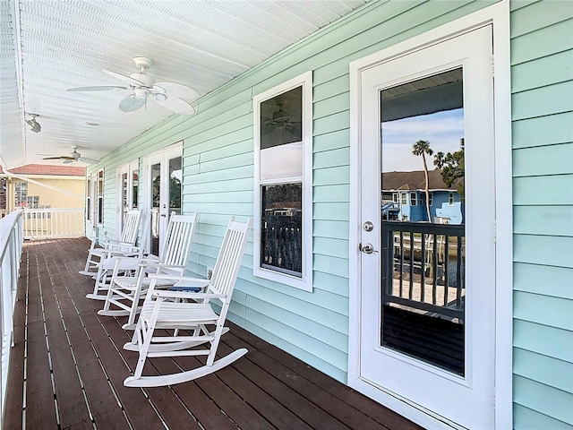 wooden terrace featuring ceiling fan and a porch