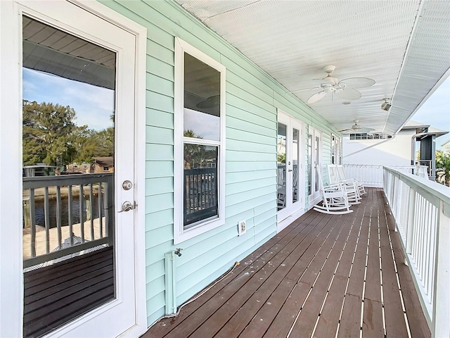 deck with ceiling fan and a porch