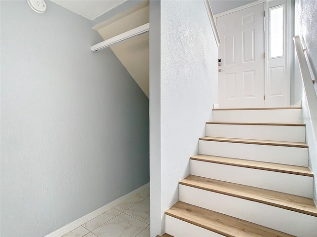 staircase with tile patterned floors