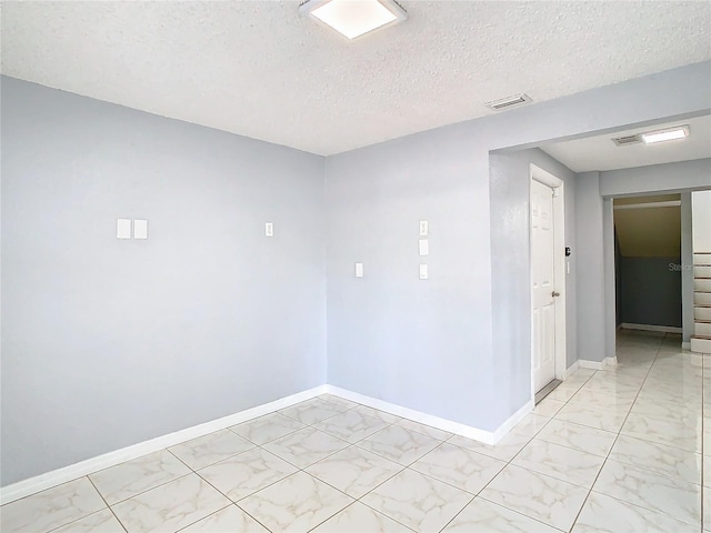 empty room with a textured ceiling