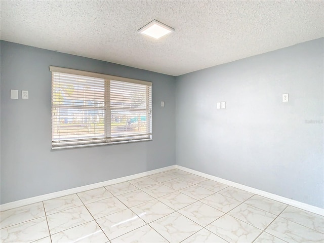 spare room featuring a textured ceiling