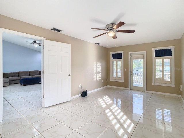 tiled empty room with ceiling fan