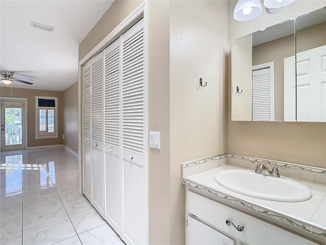 bathroom featuring tile patterned flooring, vanity, and ceiling fan