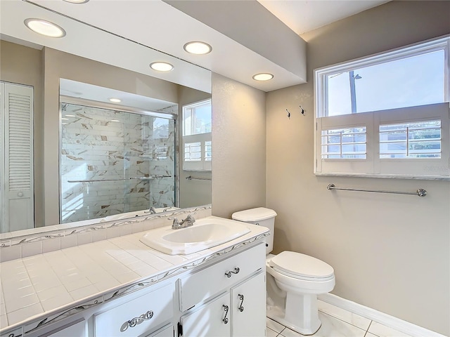 bathroom featuring toilet, vanity, tile patterned floors, and walk in shower