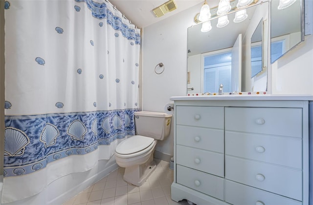 bathroom featuring tile patterned flooring, vanity, and toilet