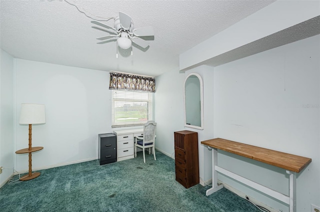 carpeted home office with ceiling fan and a textured ceiling