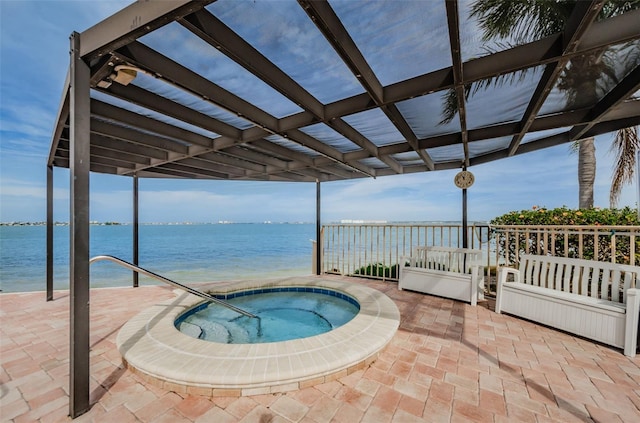 view of pool with an in ground hot tub and a water view