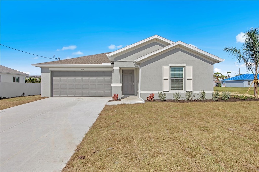 single story home with a front yard and a garage