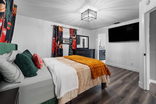 bedroom featuring dark hardwood / wood-style floors and ensuite bath