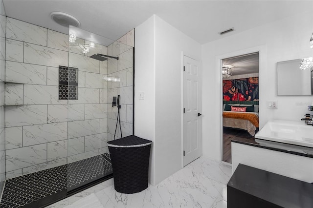 bathroom with vanity and tiled shower