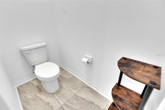 bathroom with tile patterned flooring and toilet