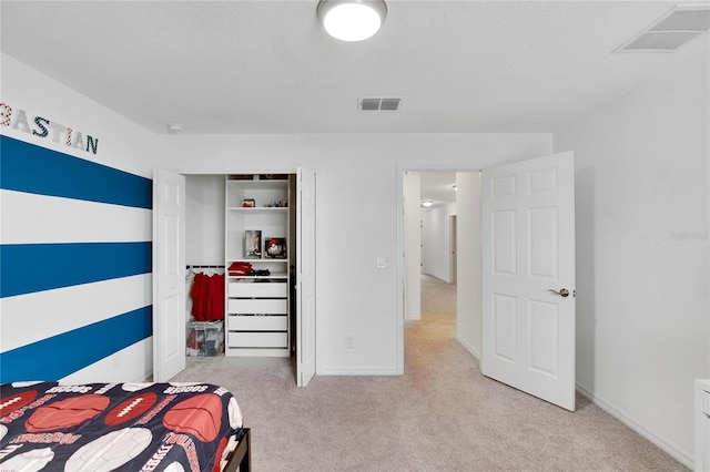 carpeted bedroom with a closet