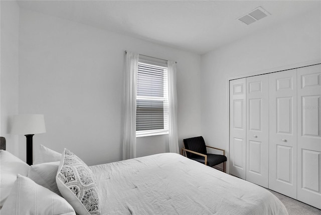 bedroom featuring a closet and light colored carpet