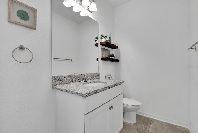 bathroom with tile patterned floors, vanity, and toilet