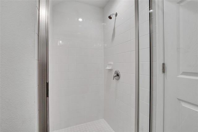 bathroom with a shower with door