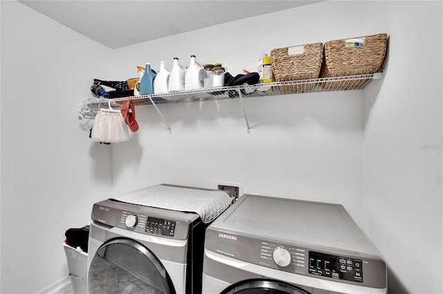 washroom featuring washer and clothes dryer