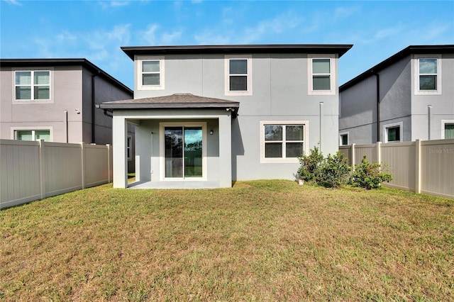 rear view of house featuring a patio and a lawn