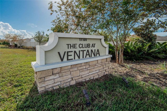 community / neighborhood sign with a lawn