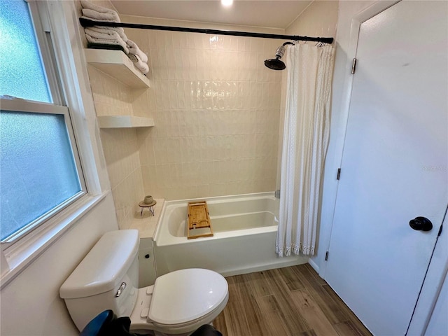 bathroom with hardwood / wood-style floors, toilet, and shower / bathtub combination with curtain